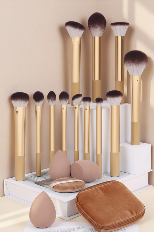 13-piece gold makeup brush set with beauty sponges and velvet pouch on tiered white display